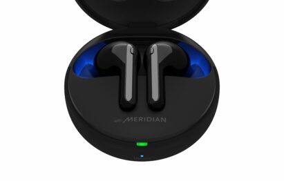 A pair of TONE Free FN7 earbuds in Stylish Black sitting inside its UVnano Charging case, which is emitting a blue light from the top of the case informing charging level and UV nano status