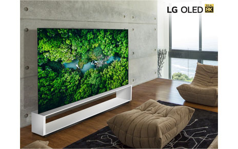 LG 8K OLED TV model 88 OLED ZX in a modern living room while displaying the vivid colors of a dense green forest.