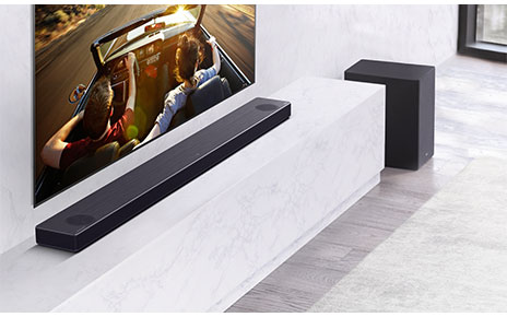 LG Soundbar model SN11RG installed on a shelf under an LG TV as it delivers truly dynamic sounds
