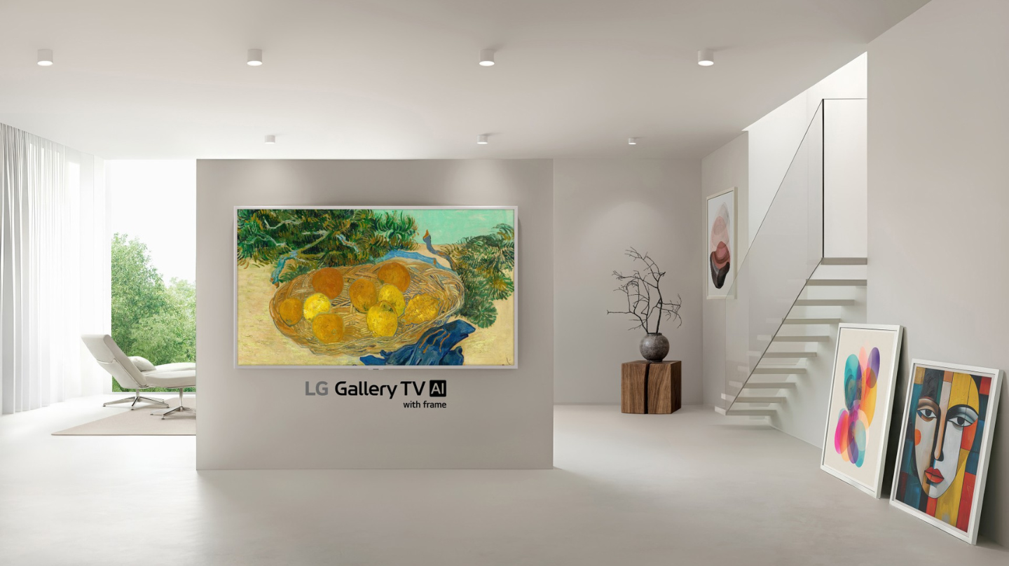 A wall-mounted LG Gallery TV with a slim white frame displays Van Gogh’s “Still Life of Oranges and Lemons with Blue Gloves” in a bright minimalist room.