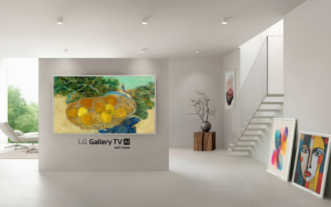 A wall-mounted LG Gallery TV with a slim white frame displays Van Gogh’s “Still Life of Oranges and Lemons with Blue Gloves” in a bright minimalist room.