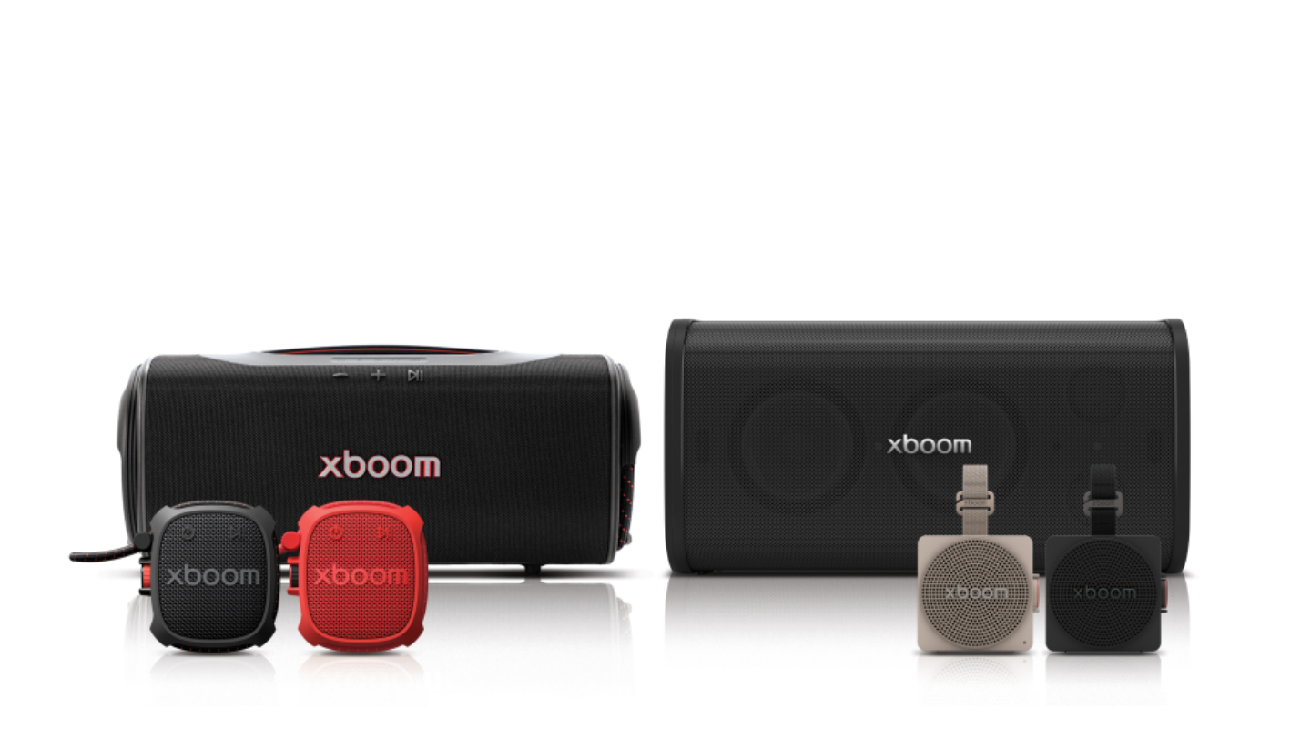 The LG xboom speaker lineup sits together, with two large models behind four compact speakers in black, red and beige.