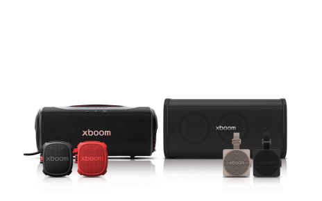 The LG xboom speaker lineup sits together, with two large models behind four compact speakers in black, red and beige.
