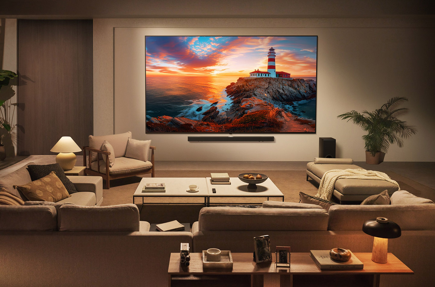 An LG QNED TV is mounted on the wall of a contemporary living room, displaying a coastal sunset landscape.