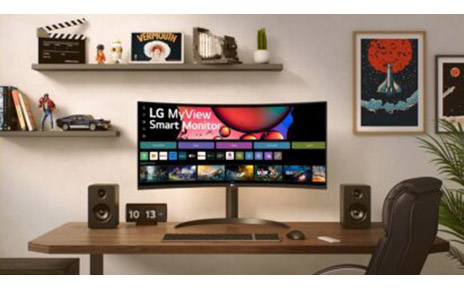 A desktop setup featuring the new LG MyView Smart Monitor with a curved design