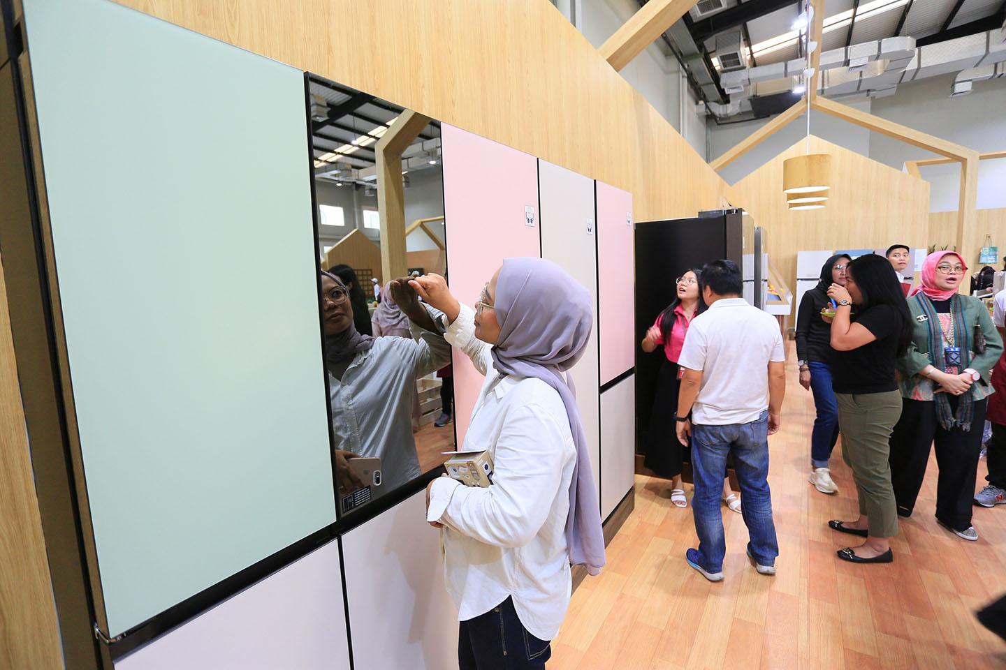 a photo of woman checking out the LG InstaView™ Door-in-Door refrigerator at the event