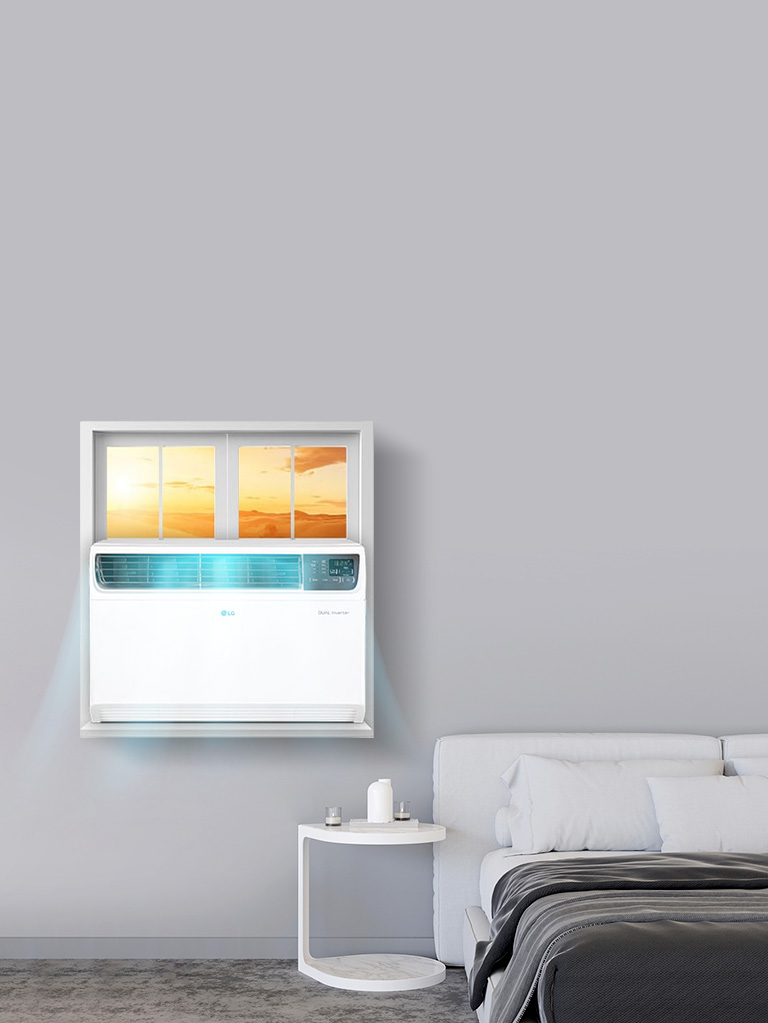 A white window air conditioner installed in a bedroom window, providing efficient cooling in a compact space