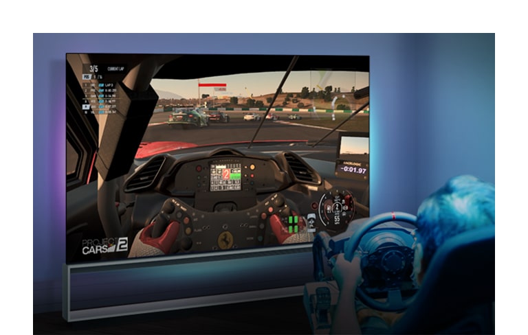 A man is playing a racing game with LG OLED TV and Xbox sereis X.