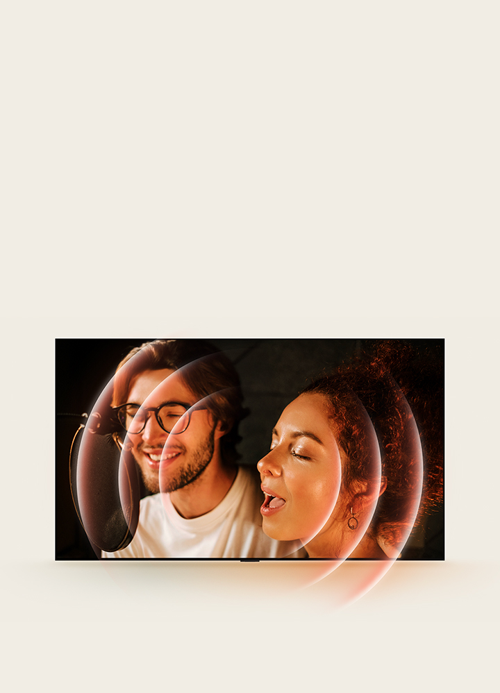 On an LG OLED TV screen are two singers in a recording studio. Around one of the singers are concentric circles representing the sound of her voice being easily heard with AI Object Remastering. 