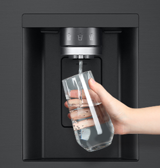  A person is getting water from the refrigerator dispenser into a glass