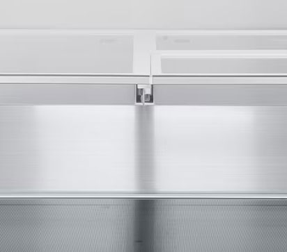 A diagonal view of the shelf with metallic paneling on the interior of the refrigerator.