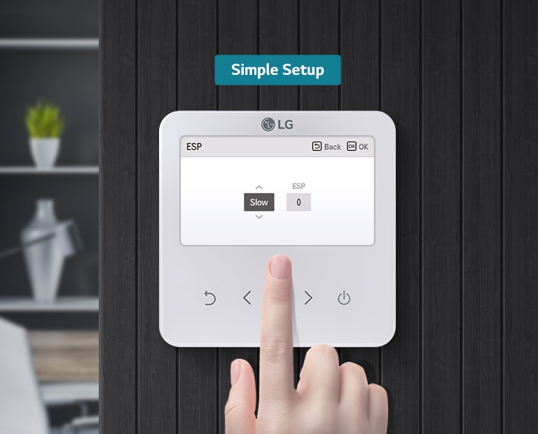 The right hand is engaging with the remote controller, which is mounted on a black wall. The controller's screen is displaying the options 'Slow' and 'ESP'.