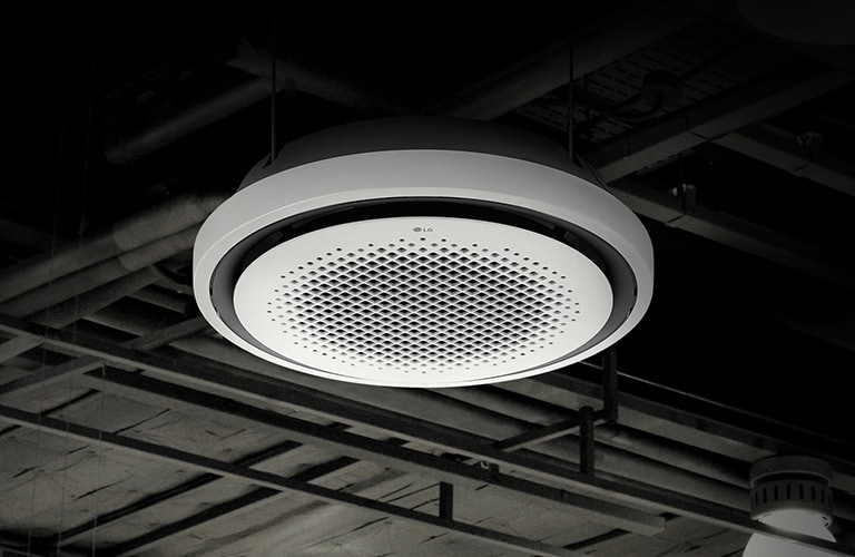 A complex network of pipes and beams adorn a black ceiling. At the center, LG Round Cassette is displayed.