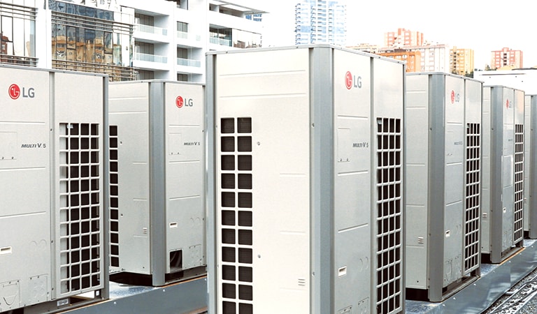 Front side view of a series of LG Multi V i units, right half covered by checkered ventilation ducts, lined up on the building roof.