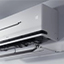 Close-up of an LG wall-mounted air conditioner with its bottom panel open for maintenance or cleaning.