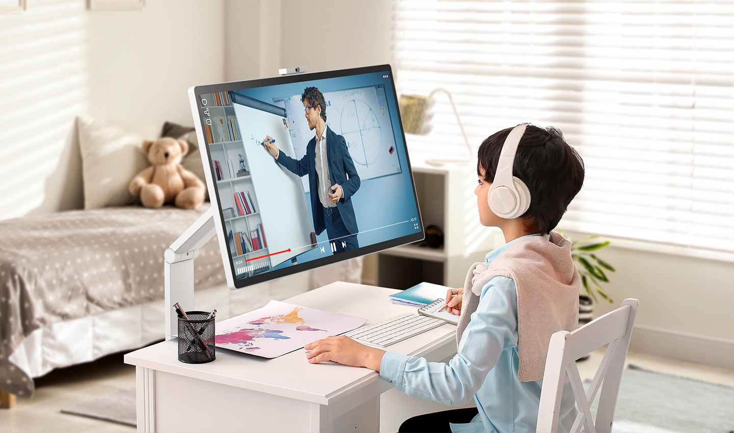 A child is watching an online class on a LG Smart Monitor Swing in a room.