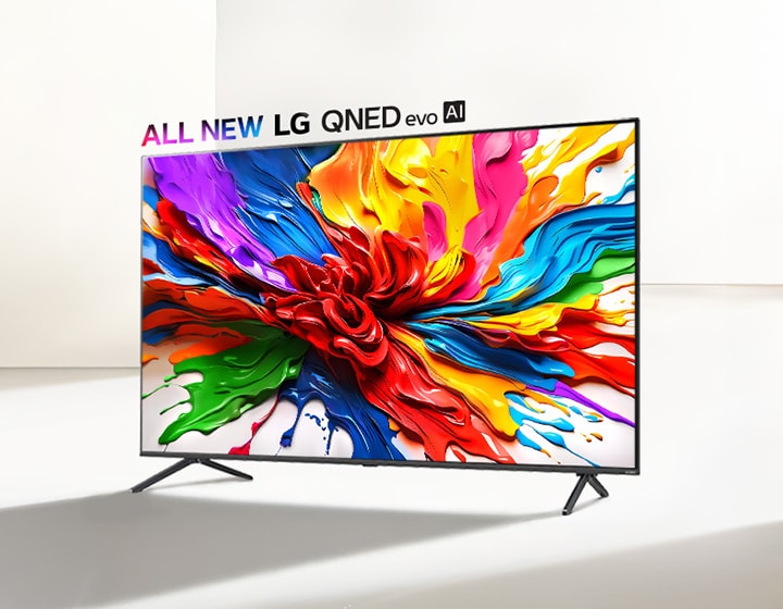 LG QNED TV on a stand in a dominantly white space. On the TV screen is a colorful splash of paint showcasing how QNED TVs can display a wide range of vibrant colors with pleasing contrast. The all new LG QNED evo AI logo is positioned above the TV. 