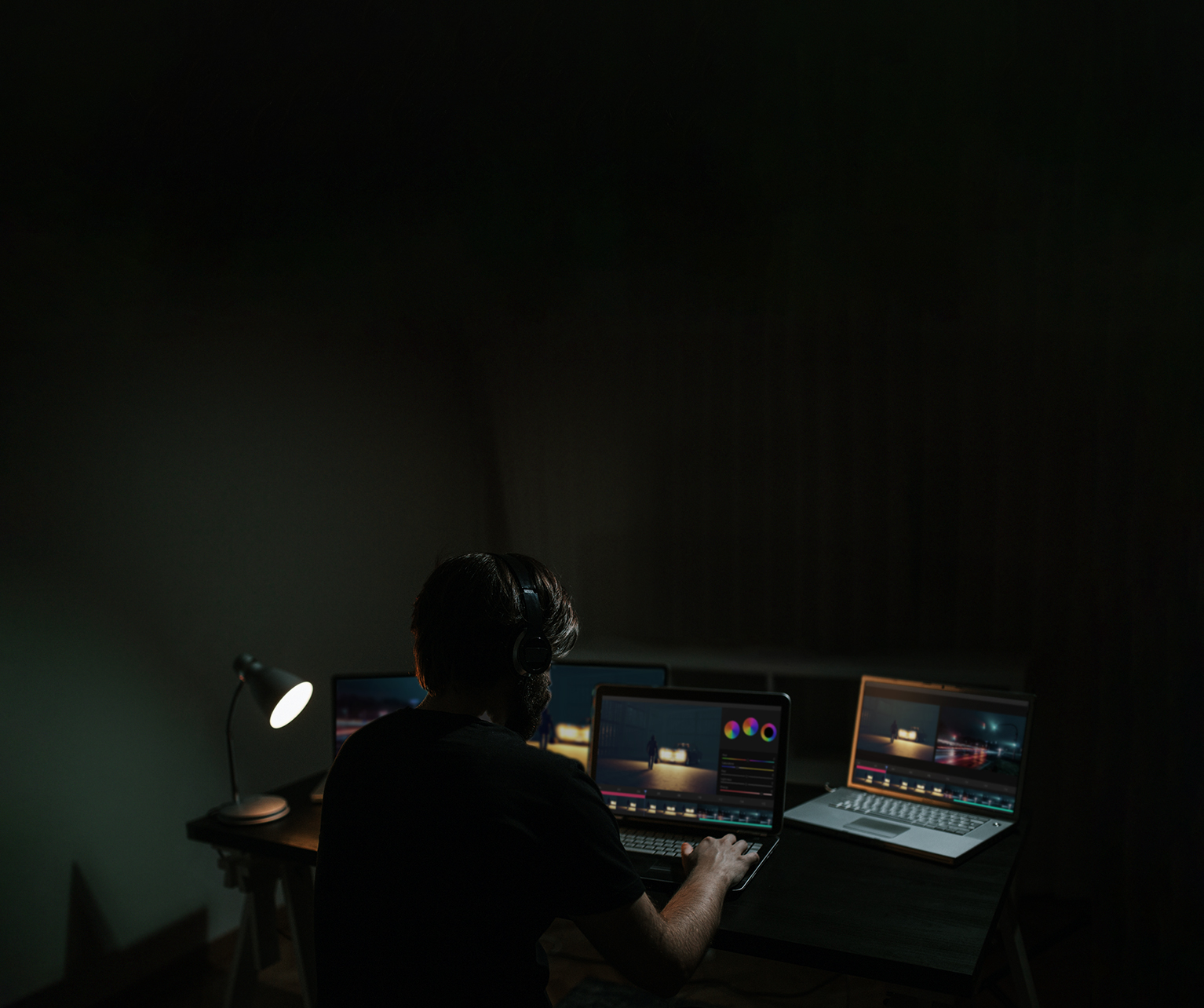 A man edits a movie while looking at the software on a computer monitor