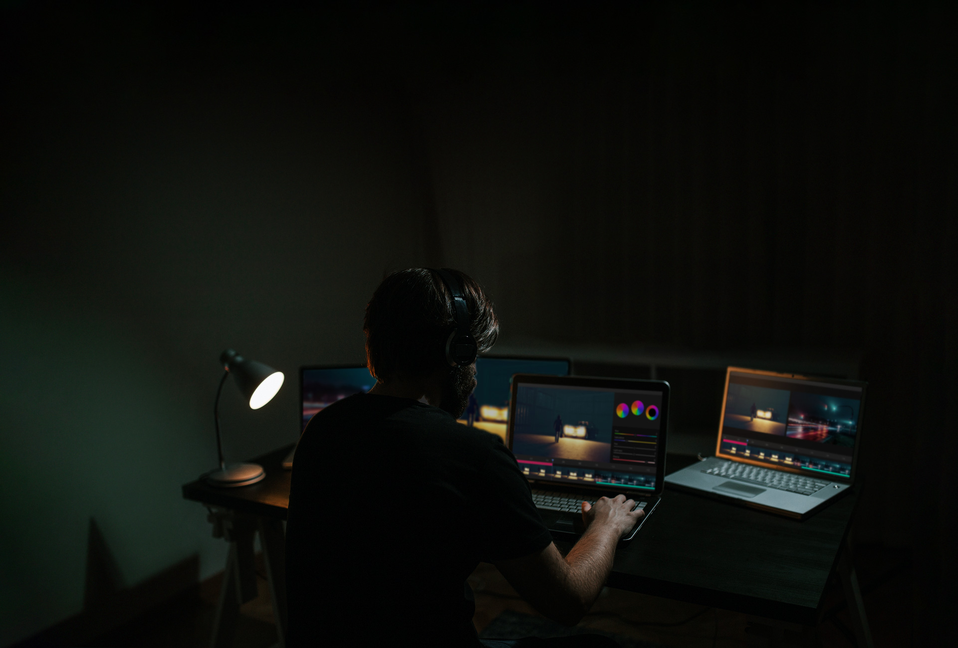 A man edits a movie while looking at the software on a computer monitor