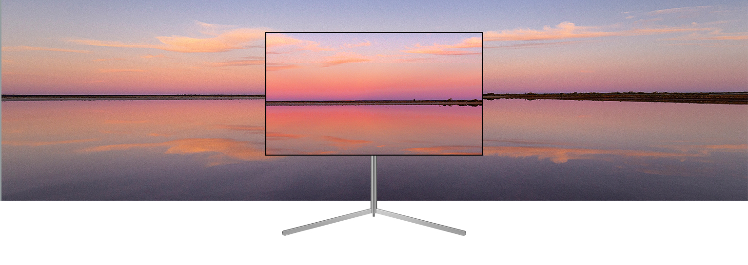 An LG OLED television on a Gallery Stand depicts a blue and pink sunset which blends into the background