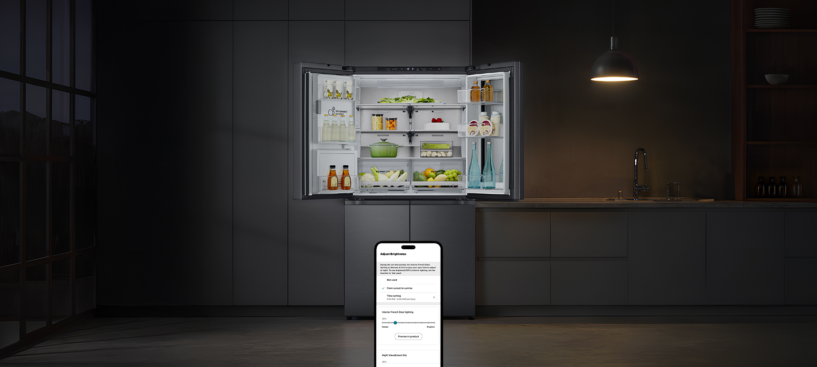 Dark kitchen with a hanging lamp above and an open LG refrigerator revealing organized food inside
