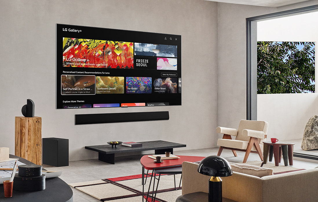 Living room with a wall-mounted LG TV. On the screen is the LG Gallery+ home screen.