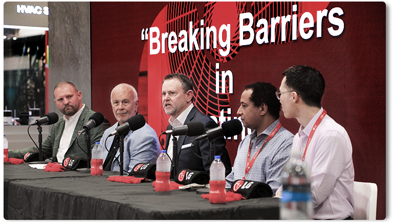 Breaking Barriers panel at a conference discussing business and technology, featuring industry professionals.