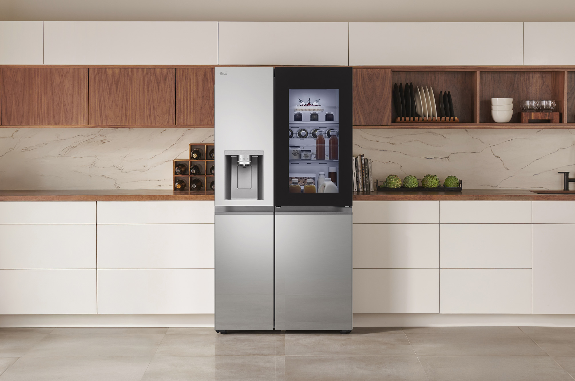 LG Side-by-Side Refrigerator GSXE81PYBD in a stainless steel finish, featuring InstaView™ Door-in-Door® and a dispenser, seamlessly integrated into a modern kitchen with white and wood cabinets.