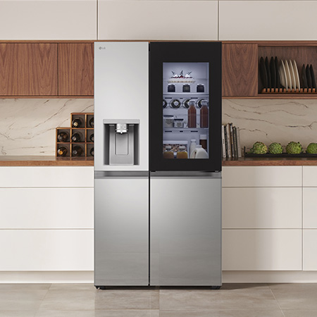 LG Side-by-Side Refrigerator GSXE81PYBD in a stainless steel finish, featuring InstaView™ Door-in-Door® and a dispenser, seamlessly integrated into a modern kitchen with white and wood cabinets.