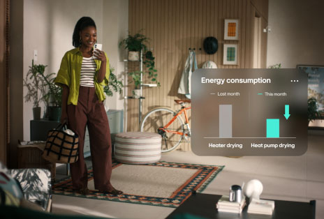 A video of a woman in yellow shirt smiling at her phone with a graph showing reduced energy consumption.