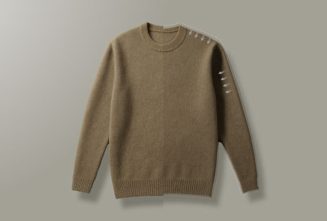 A video showing a brown sweater not shrunk after drying and a man pleased with the fabric texture of clothes.