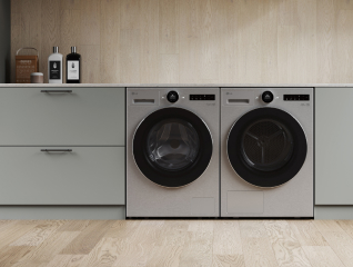 In the laundry room, a silver LG washing machine and dryer are placed side by side, with gray drawers positioned next to them.