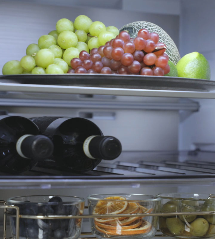 LG fridge freezer (GBBS726CEV) interior view with fruits on top shelf wine bottles in middle and more fruits on bottom shelf