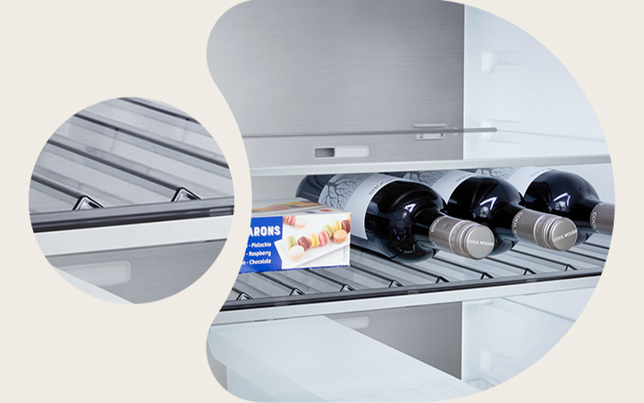 LG fridge freezer (GBBS726CEV) close up of wine rack holding four bottles and box of macarons with rack design magnified in circular image