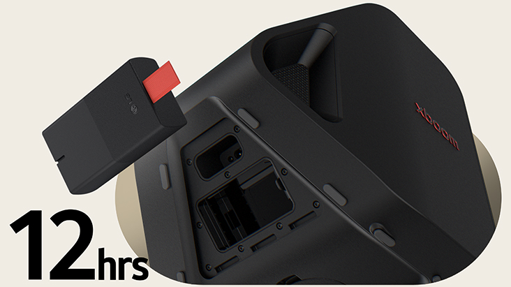 Rear side of Stage 301 is shown with its battert part open. A replaceable battery is hanging on the air right next to the xboom Stage 301.
