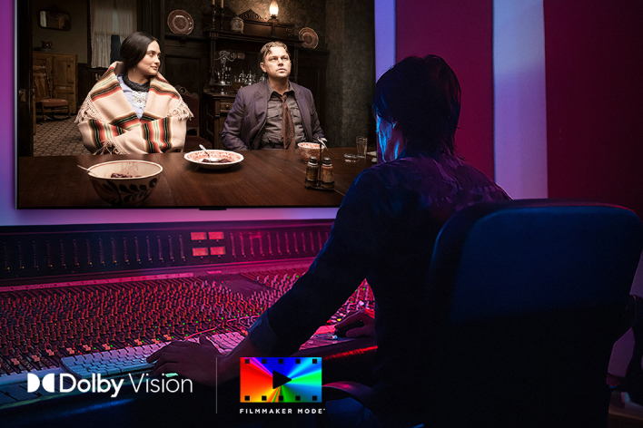 A director in front of a control panel editing the movie "Killers of the Flower Moon" on an LG OLED TV. In the bottom left, the Dolby Vision logo and FILMMAKER MODE logo.	