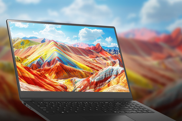 A laptop displaying a vivid and colorful landscape of vibrant mountains on its screen, emphasizing high-resolution and rich color reproduction. The background features a blurred version of the same landscape, drawing attention to the screen quality.