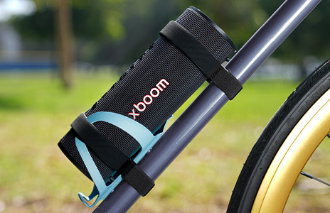 xboom Grab is placed on a bicycle's water bottle holder.	
