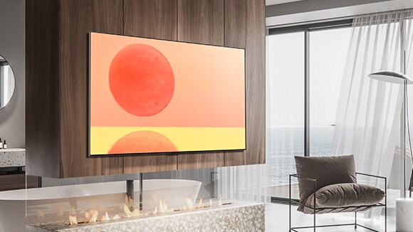 تلفزيون OLED G2 من إل جي معلق على الجدار في غرفة بنية وبيضاء مع ملحقات حمراء اللون