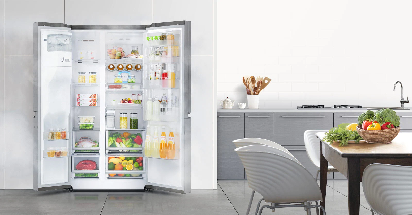 A woman stands in front of the refrigerator holding a glass of juice and smiling as she closes the door.