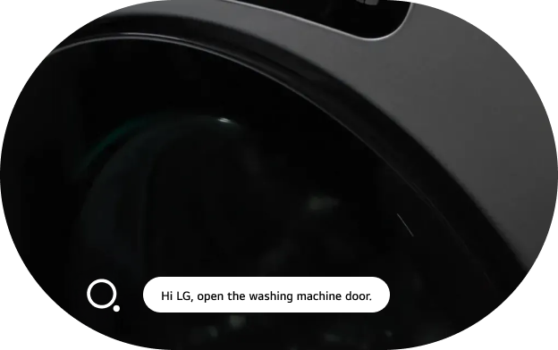 An image of the LG washing machine AI voice recognition feature. The top portion of an LG washing machine is shown in close-up, displaying a voice recognition icon alongside the text 'Hi LG, open the washing machine door,' with the washing machine door open.